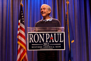 Ron Paul standing on a podium to deliver speech