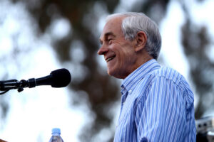 A man delivering speech standing on the podium